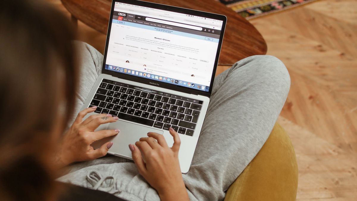 Woman browsing an online store on her laptop at home