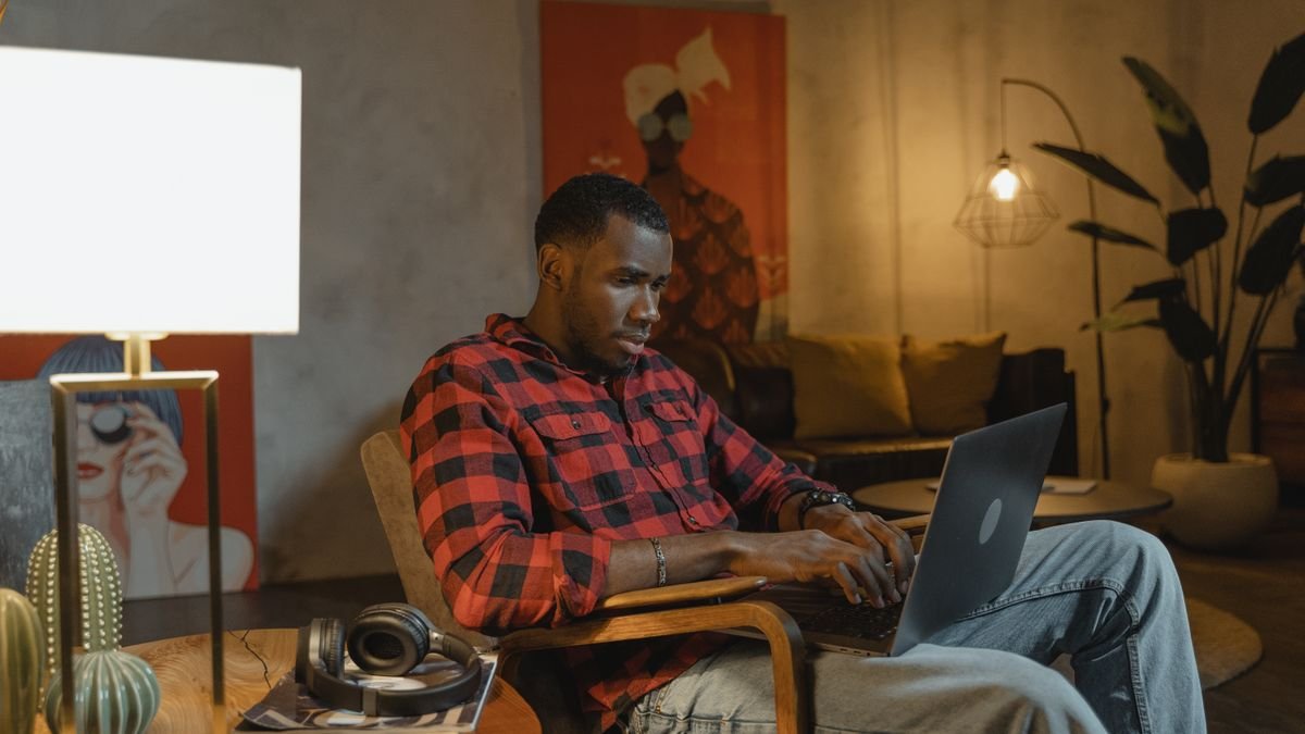 Man working on a laptop in a cosy home office
