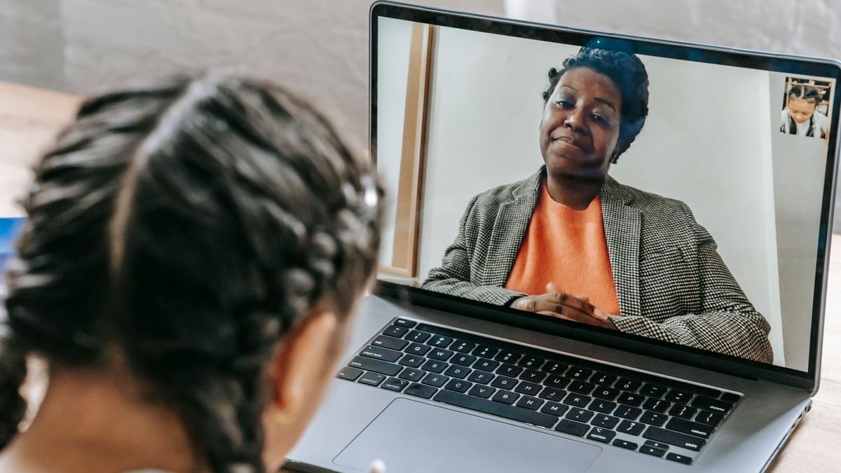 Student taking an online lesson with a tutor on a laptop