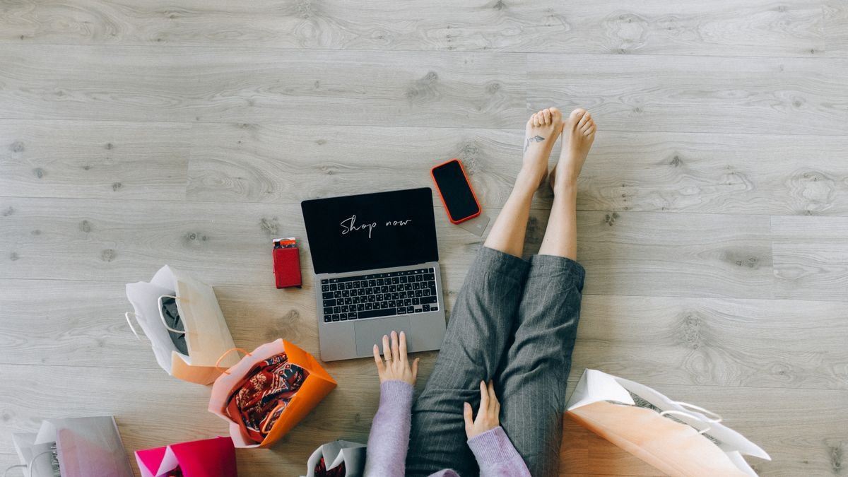 Laptop and shopping bags on the floor after an online order