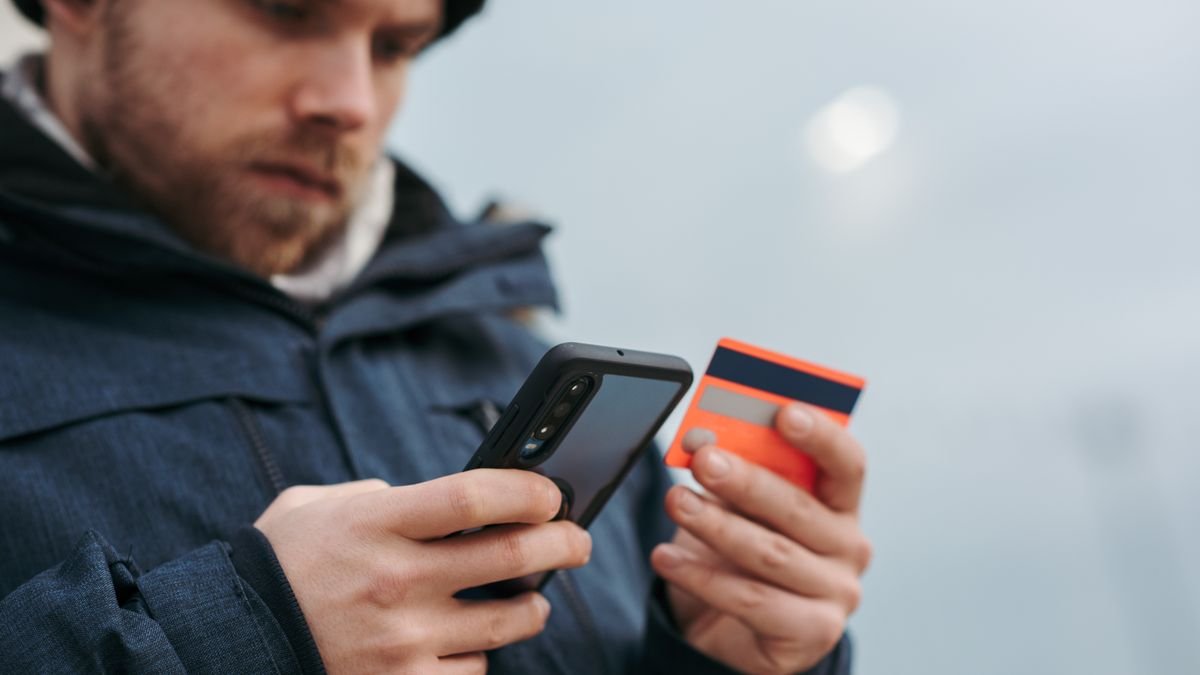 Person typing card details into a phone, the moment to check a deal is real