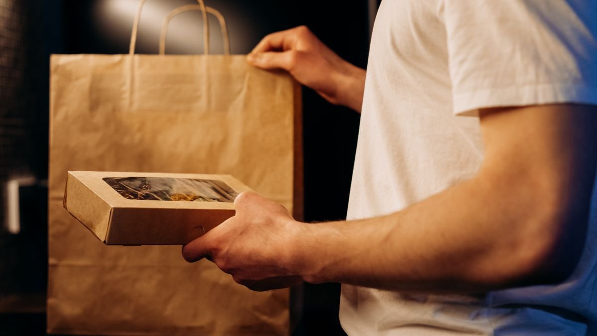 Food delivery bag being handed over at home