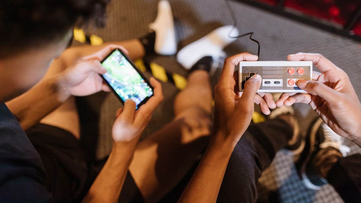 Teenagers playing games on their phones